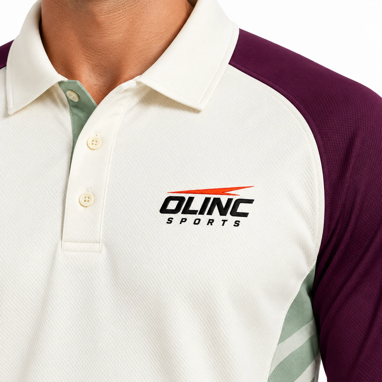 Cricket Pavilion Long-Sleeve Kit zoom design view showing ivory shirt, aubergine raglan sleeves and muted-sage geometric side inserts; ivory trousers with aubergine outer-leg piping