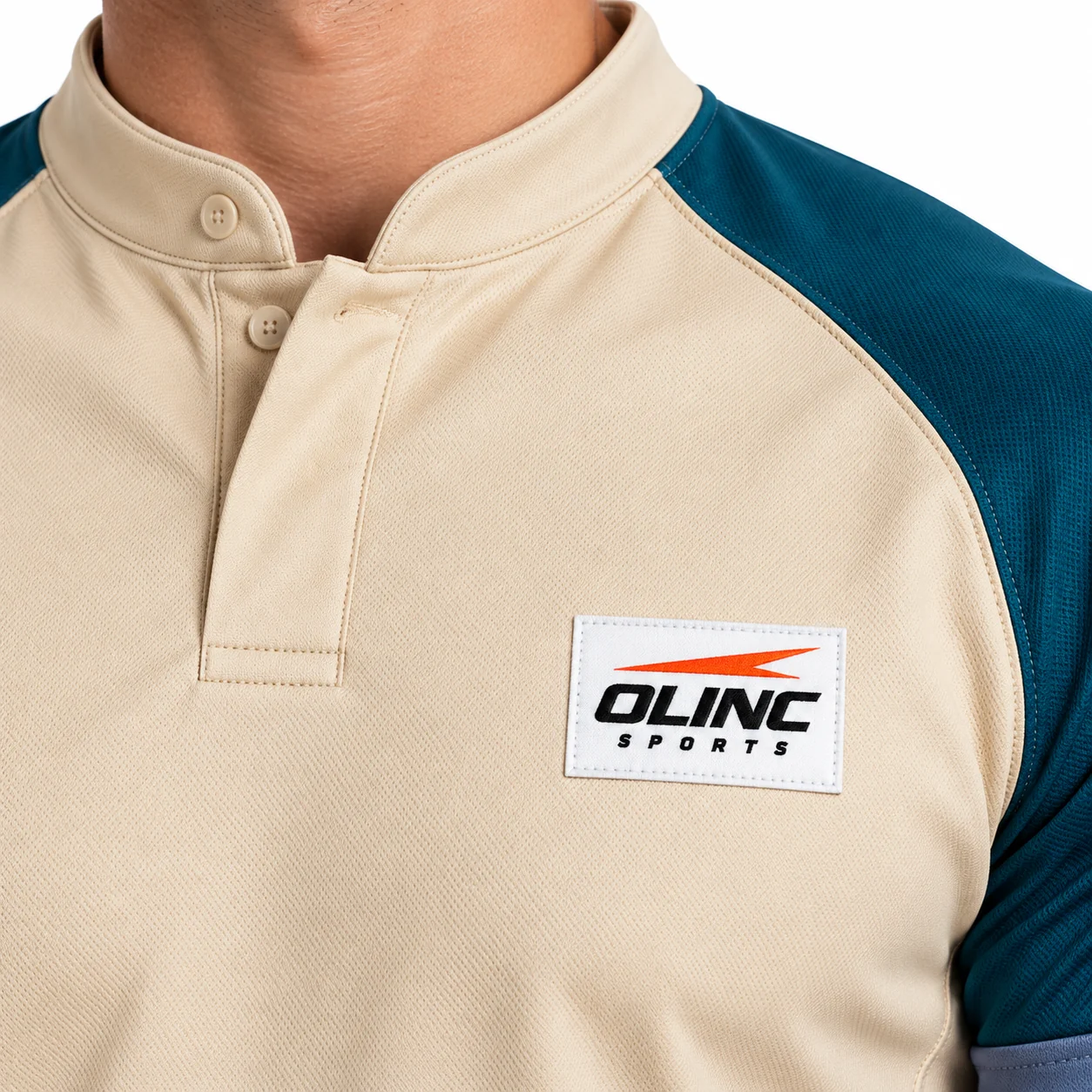 Rugby Keystone Stand-Collar Jersey zoom design view showing sand torso, deep-teal curved shoulder panels and slate-blue sleeve cuffs