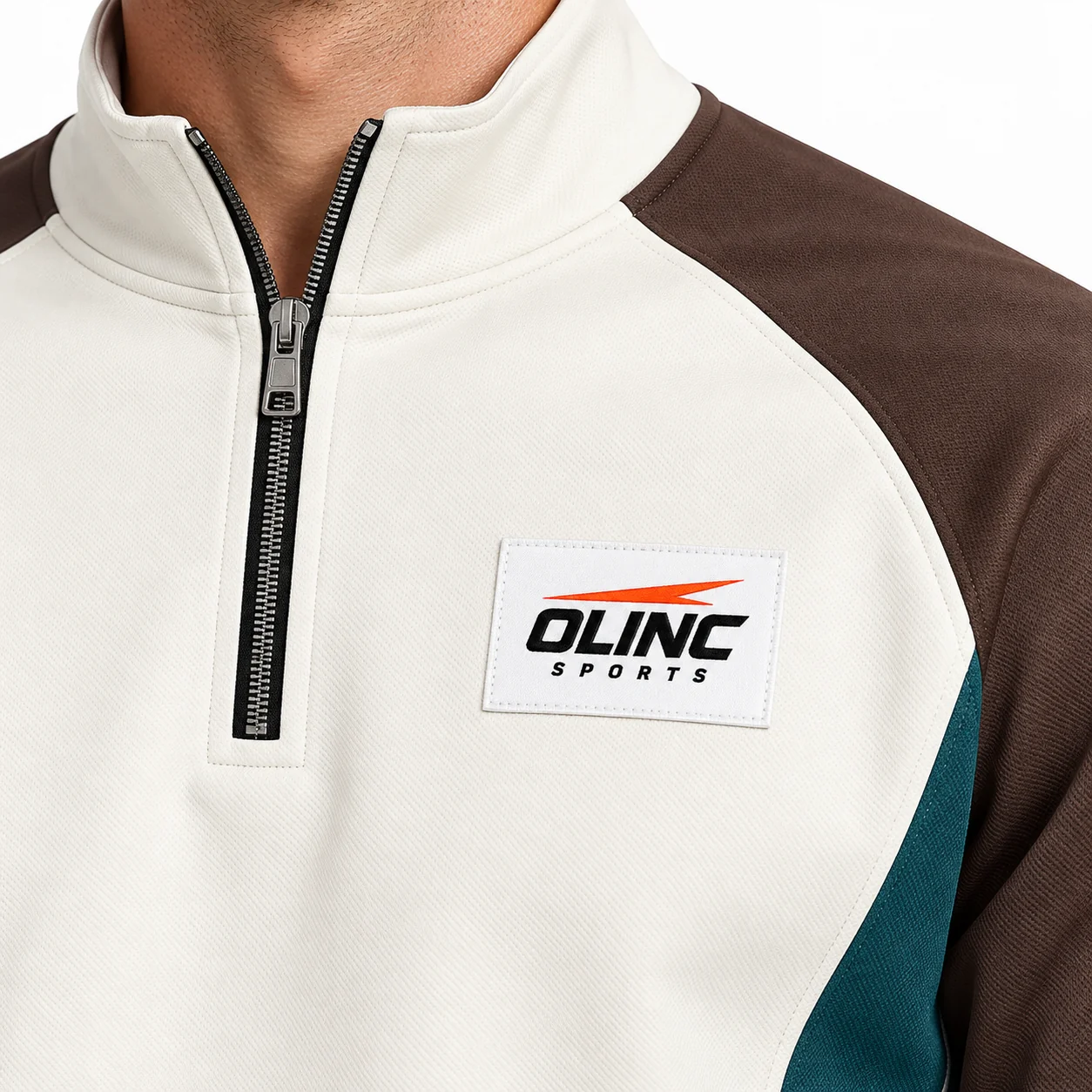 Tracksuit Crestline Half-Zip Set zoom design view showing bone top, steel-brown raglan sleeves and deep-teal side inserts; bone straight-leg trousers with deep-teal outer-leg panels