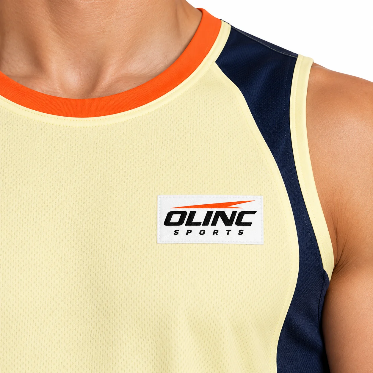 Handball Pulse Tank Training Top zoom design view showing bone-yellow body, ink-navy upper-side panels and muted-orange neck binding