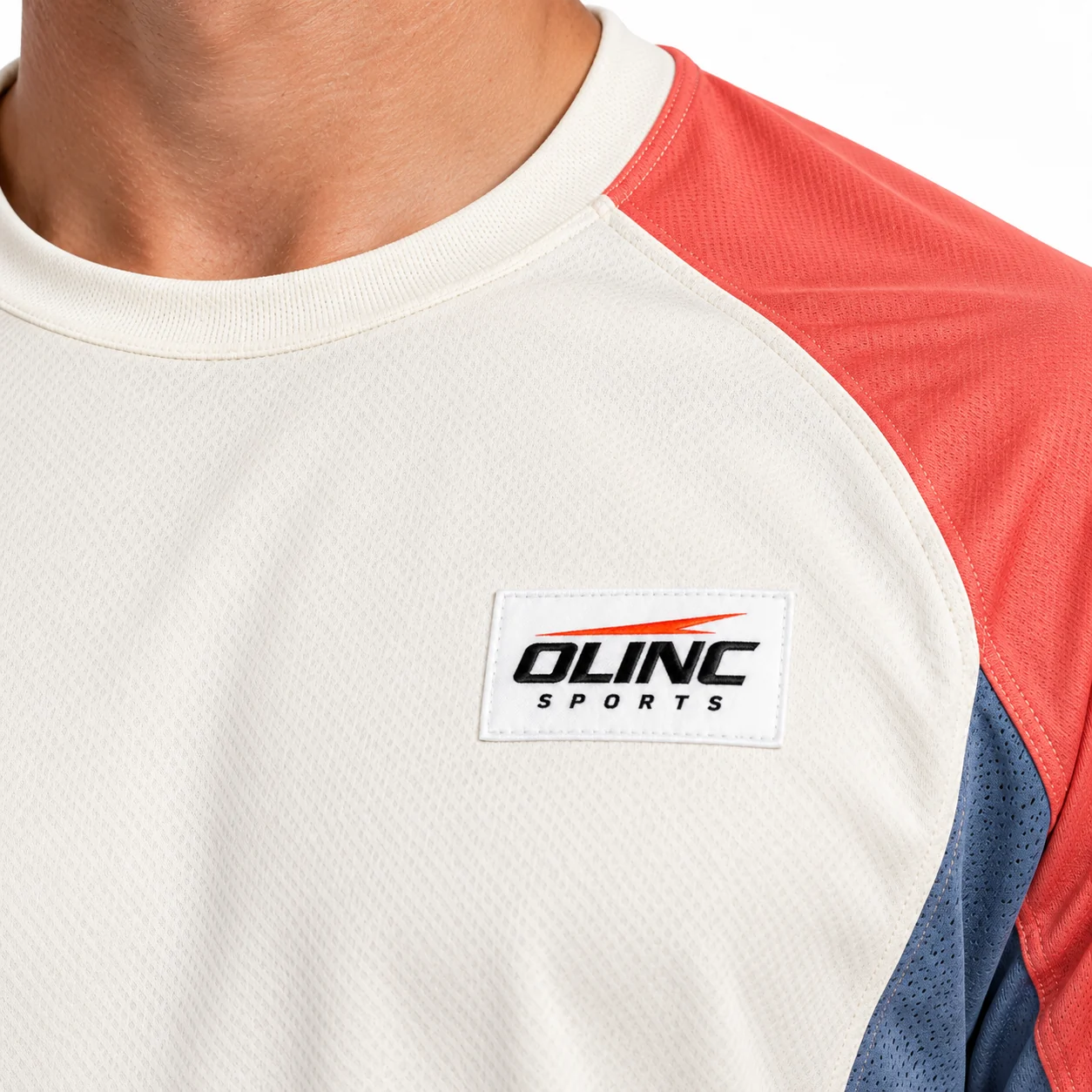 Lacrosse Stratum Long-Sleeve Top zoom design view showing cream body, muted-coral raglan sleeves and cadet-blue curved underarm inserts