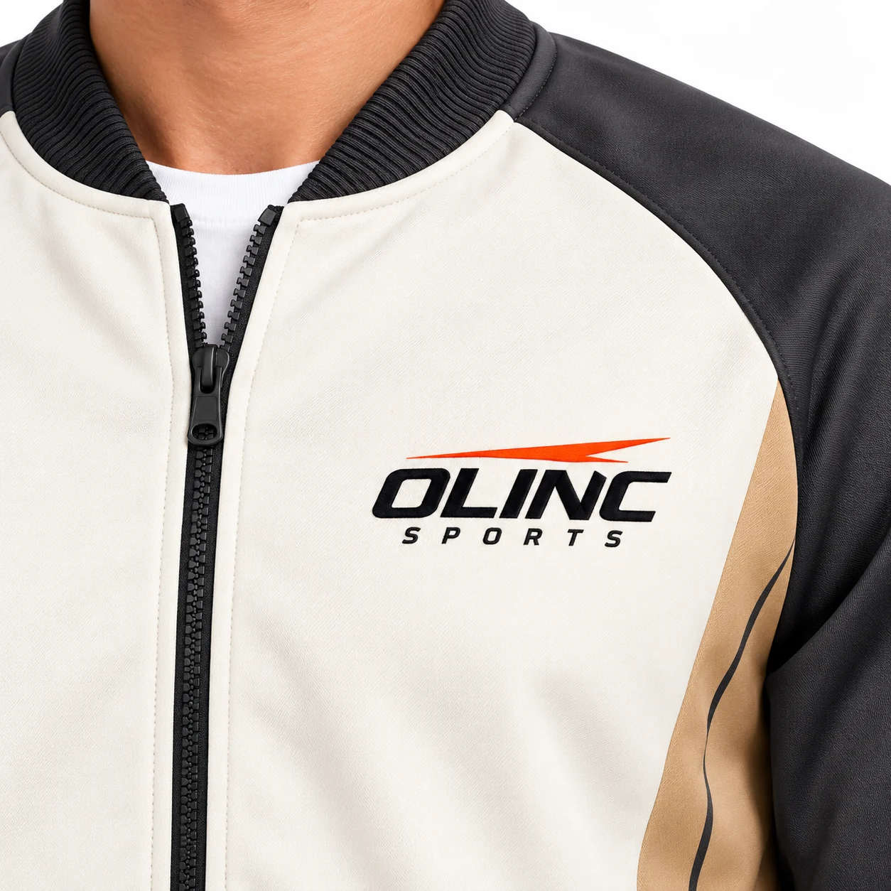 Tracksuit Station Rib-Collar Set zoom design view showing ivory bomber-style jacket, charcoal sleeves and tan side inset panels; charcoal cuffed cargo trousers