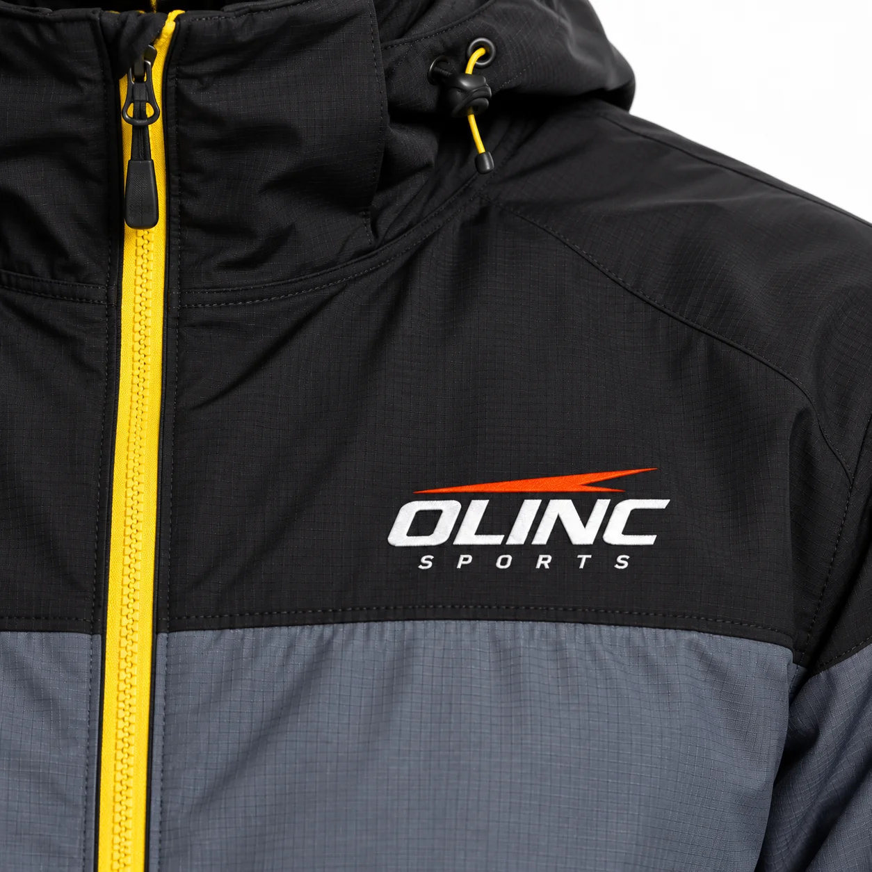 Sideline Ripstop Jacket zoom design view showing slate shell, black shoulders and muted-yellow zipper detail