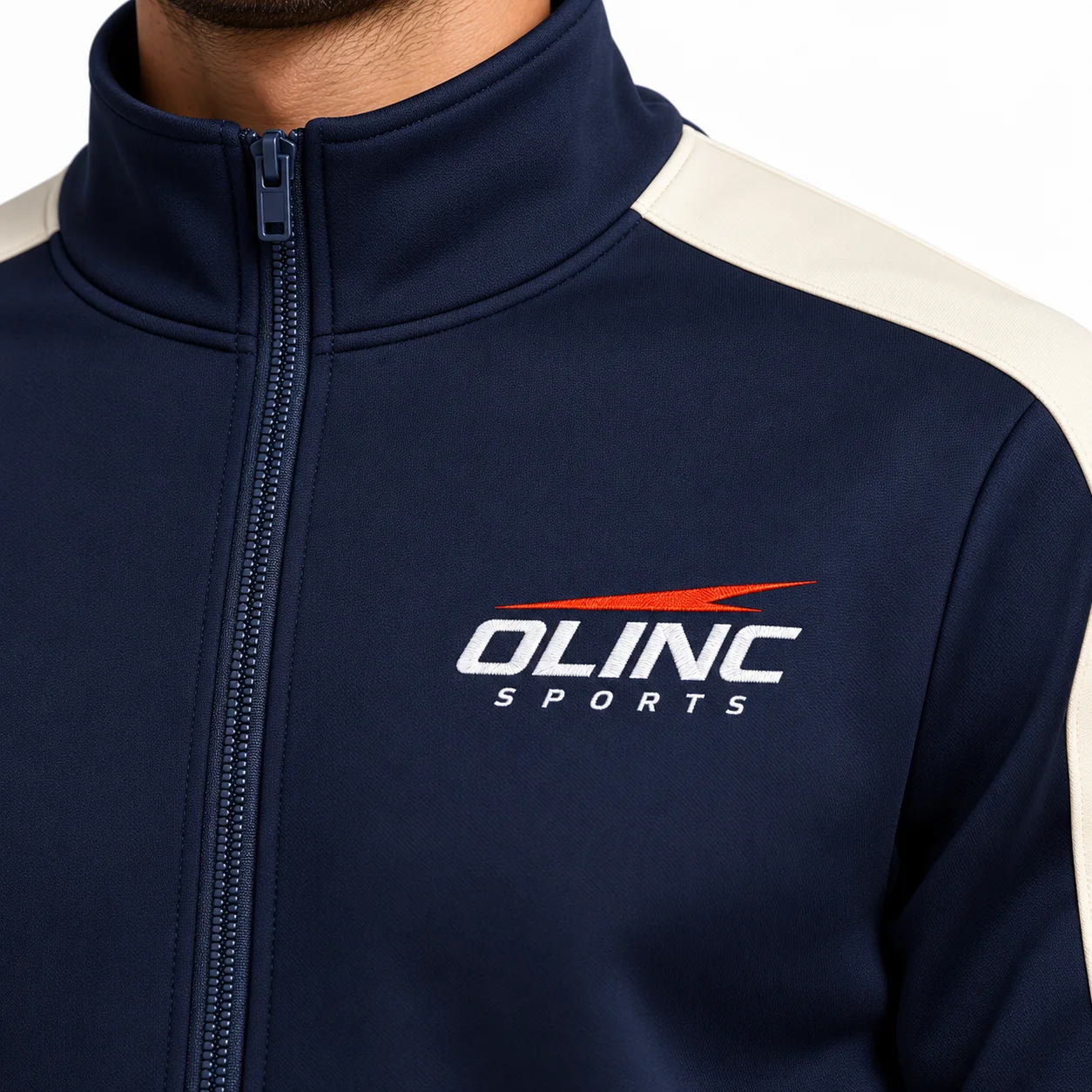 Transit Scuba Tracksuit zoom design view showing midnight-navy set with cream sleeve inserts and tonal hardware